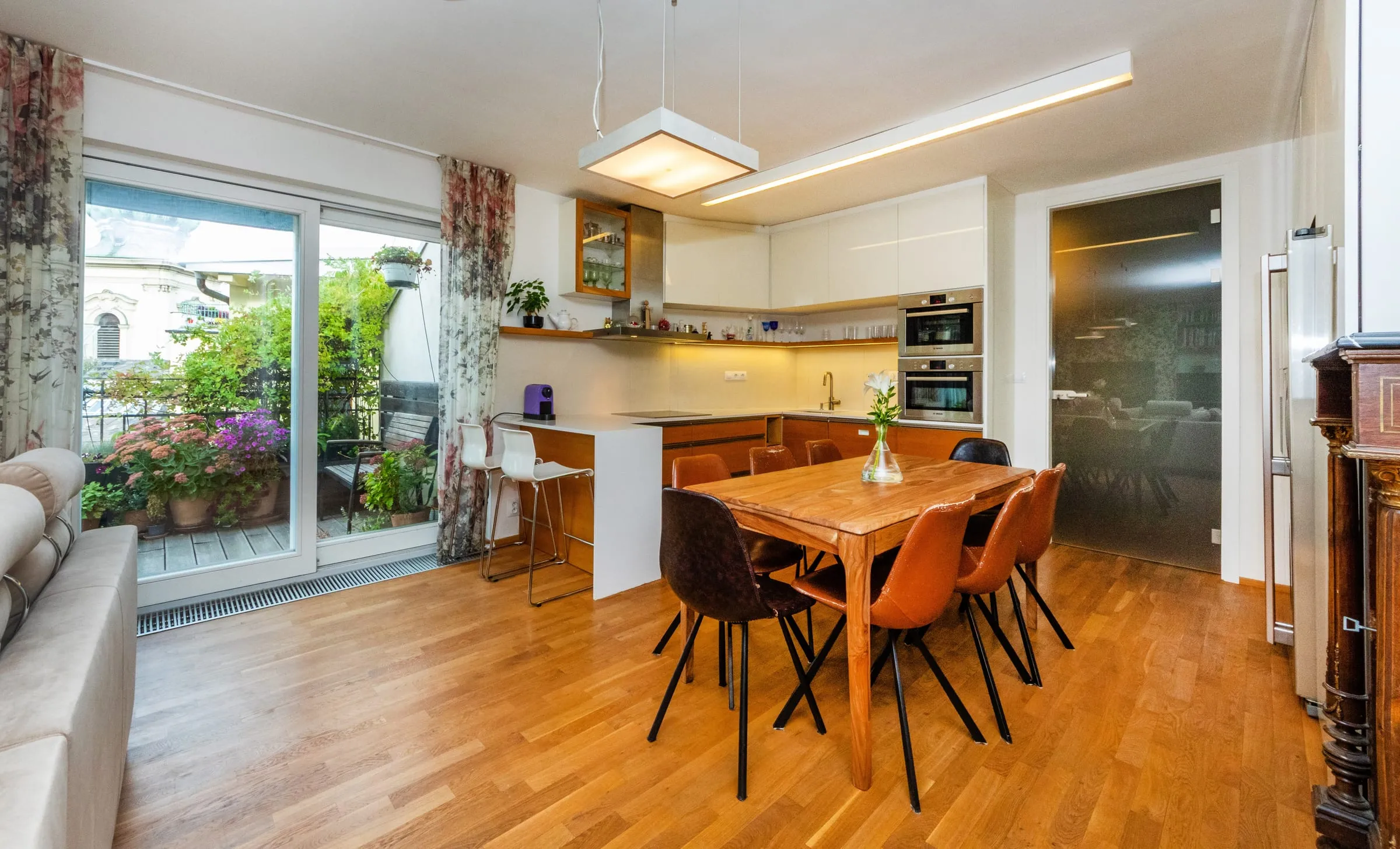 Kitchen and dining table with the terrace doors open