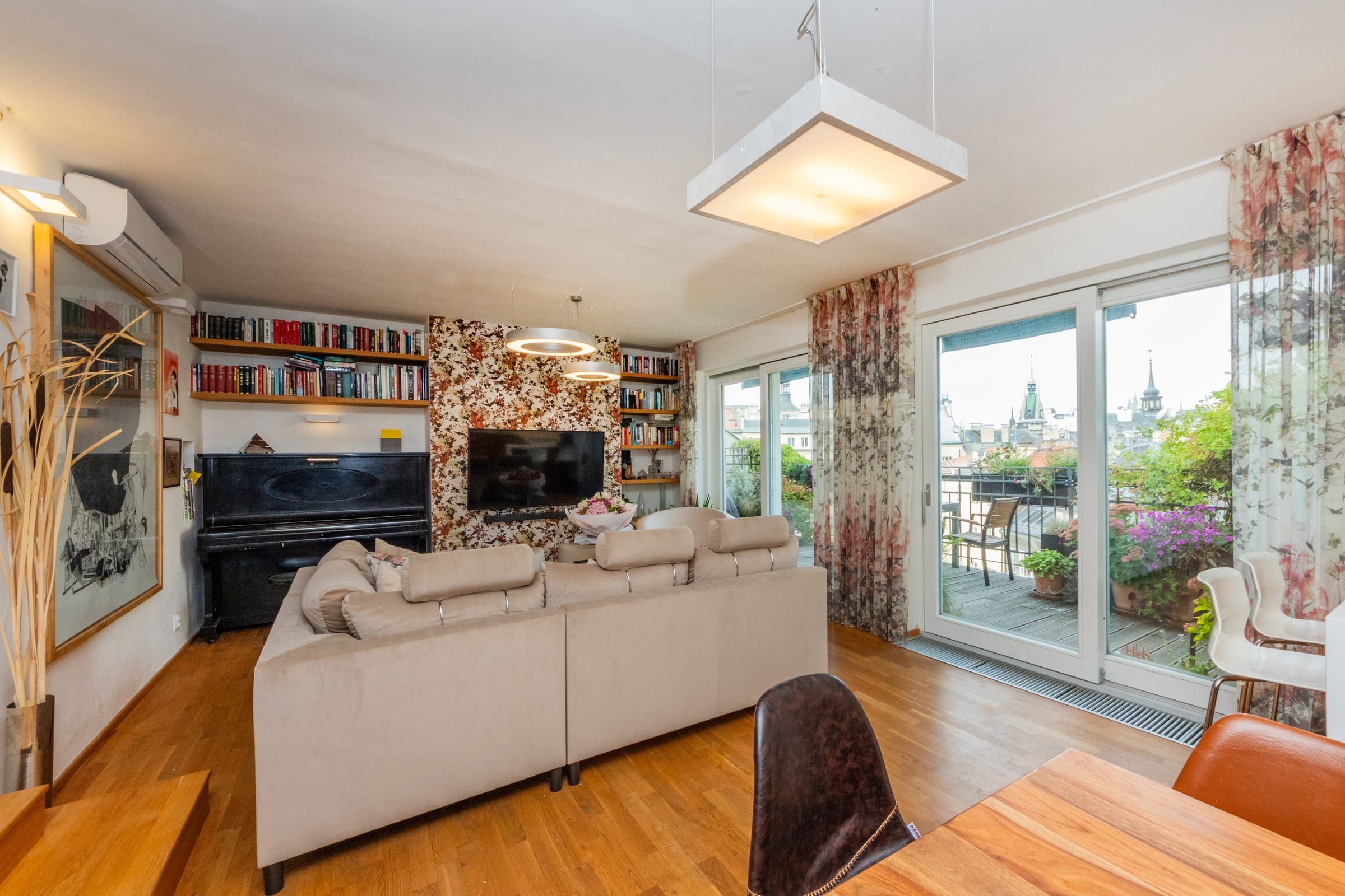 Living room with a piano and glass doors to the terrace